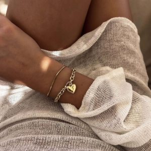 Gala Bracelet featuring a gold chain design with a heart charm, perfect for layering and minimal style.