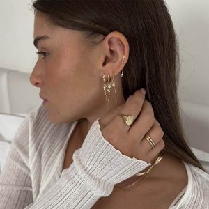 Anne Earring Set featuring crystal pearls and delicate chains worn by a model with stylish hoop earrings.