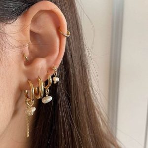 Celine Earring Set featuring gold hoops and pearl accents creating an asymmetrical look.