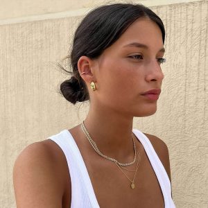 Model wearing a Double Bar Necklace with an oval engraved wildflower pendant.