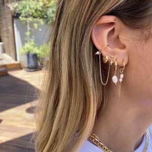 Emily Earring Set featuring elegant hanging chain links and pearl embellishments on a model's ear.