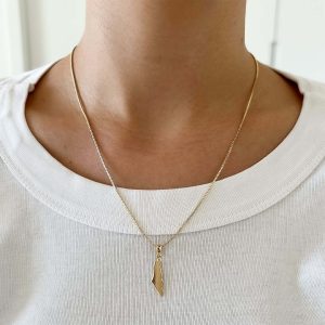 Map of Israel Necklace featuring a gold-plated pendant worn on a person, showcasing its stylish design.