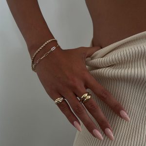 Mali Bracelet worn on hand with gold and silver rings, showcasing style and elegance in 14K gold plated brass.