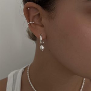 Mali Earrings - 925 Sterling Silver featuring elegant pearl drop hoop design worn on model.