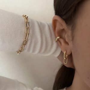 Sleek and stylish Maple Bracelet worn alongside minimalist gold earrings, perfect for stacking or solo statements.