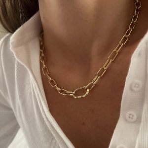 Maple Necklace featuring bold gold chain with oval links worn close-up on model's neck.