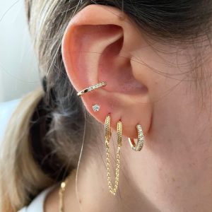 Melissa Ear Cuff displayed on a model's ear, featuring crystal accents and a stylish design without piercings.