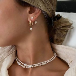 Monaco Necklace styled with mixed pearl sizes and gold beads, paired with elegant earrings.