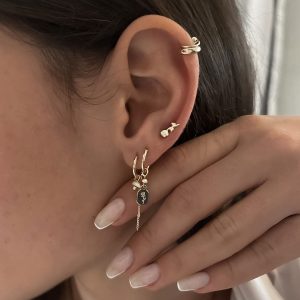Rose Stud Earrings worn alongside other trendy ear piercings, showcasing a delicate and layered look.