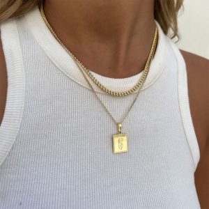 Shay Necklace worn with a gold chain design clasp, ideal for layering with other delicate jewelry.